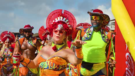 Gold-yellow-and-blue-shining-costumes-as-woman-blows-kiss-wearing-red-headdress