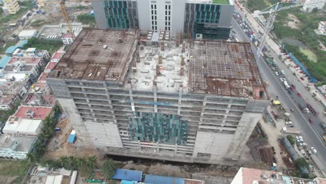 Aerial-video-showing-a-twin-tall-highrise-building's-construction-and-installation-of-sustainable-solar-panels-for-partial-energy-consumption