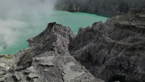 Cinematic-drone-shot-over-Ijen-Volcano's-lava-fields-and-acid-lake