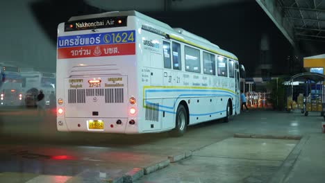 View-from-the-other-side-of-the-windshield-of-a-bus-parked-at-a-terminal-in-Bangkok,-Thailand-at-night