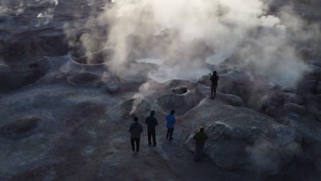 Aerial-orbits-backlit-steam-rising-from-geological-hot-spot,-geysers