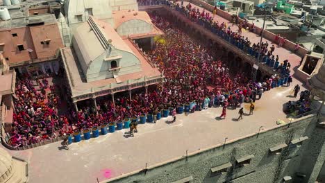 Aerial-drone-view-drone-going-to-side-in-where-lots-of-people-are-playing-with-colors-and-dancing