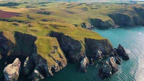 St-Abbs-Head-from-Above:-Cliffs,-Rocky-Coastline,-and-Lighthouse,-Scotland-Coast,-United-Kingdom