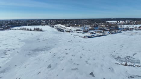 Drone-flight-over-a-frozen-lake-and-the-city-of-Lappeenranta-in-Finland