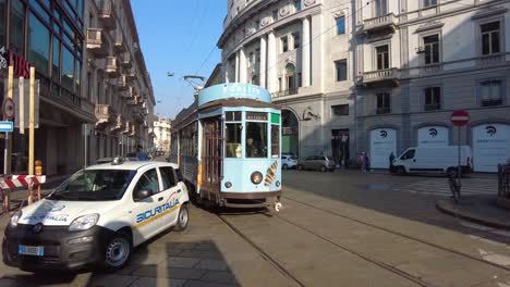 Cars,-trams-and-security-vehicle-driving-on-the-streets-of-Milan,-Italy