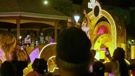 Beauty-pageant-winners-wave-hands-paraded-on-golden-float-at-night