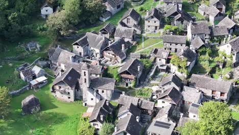 Stone-village-by-Foroglio-Waterfall,-Tessin,-Switzerland---aerial