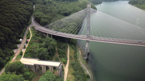 Upward-Dolly-with-Pan-Aerial-of-a-Suspension-Bridge-Over-a-River