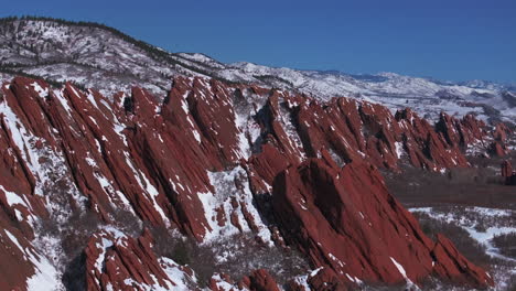 March-winter-morning-snow-stunning-Roxborough-State-Park-Littleton-Colorado-aerial-drone-over-sharp-jagged-dramatic-red-rock-formations-Denver-foothills-front-range-landscape-blue-sky-circle-right