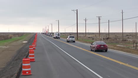 Vehicles-Driving-On-Busy-Highway-With-Road-Pylons-On-Left-Roadside