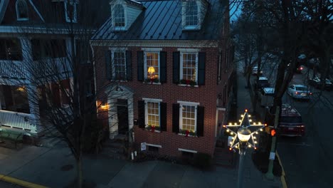 Quaint-brick-house-on-town-main-street-in-USA-decorated-for-Christmas
