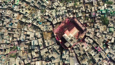 Aerial-drone-view-top-angle-shot-A-very-big-city-is-visible-where-there-is-a-big-temple-where-a-lot-of-people-are-playing-dhuleti