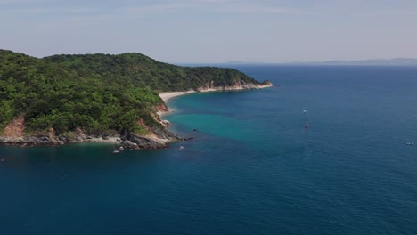 Panoramic-aerial-drone-fly-above-peninsular-landscape,-Japanese-blue-sea-summer