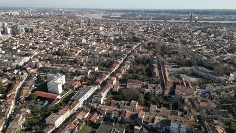 Old-City-center-with-Garonne-river-in-the-distance-in-Bordeaux-France,-Aerial-dolly-right-shot