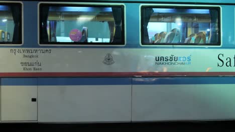 A-newly-arrived-passenger-bus-is-moving-from-the-right-to-the-left-side-of-the-frame-is-parking-at-Mochit-Terminal-in-Bangkok,-Thailand