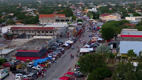 Curved-road-lined-with-families-under-pop-up-tents-to-watch-Gran-Marcha-parade