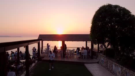 Viewpoint-Terrace-full-of-Tourists-Contempling-Sunset,-Corfu,-Greece