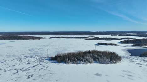 Aerial-video-over-a-frozen-lake-and-island-with-trees