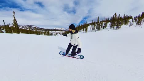 wide-open-shot-of-snowboarder-at-a-ski-resort-down-a-mountain-in-Colorado