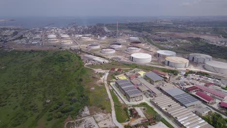 Aerial-orbit-over-the-old-empty-fuel-storage-facility-and-oil-refinery-in-Catania,-Sicily,-Italy