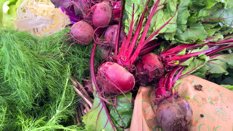 Fresh-organic-beetroot-and-dill-herb-for-sale-at-a-local-farmers-market-in-Marbella-Spain,-healthy-bio-vegetables,-4K-shot