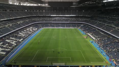 establishing-shot-Real-Madrid-stadium-almost-empty-after-football-soccer-corazon-classic-match-Real-Madrid-legends-vs-Oporto-vintage-in-march-2024-during-match-break