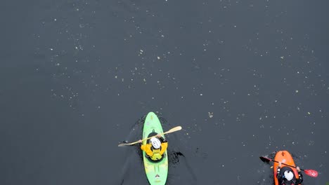 3-Colorful-Kayaks-on-a-Shadowy-river-paddling-through-a-water-adventure