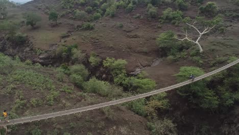 Shot-of-stunning-natural-scenery-with-a-suspension-bridge-over-a-river-in-Yemen