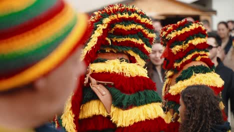 Crowd-Engages-with-Parading-Caretos,-Podence-Portugal