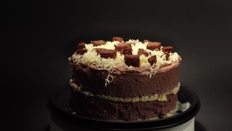 Brownie-and-cheese-cake-delicious-treat-tasty-sweet-in-a-turn-table-black-background