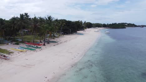 Beached-Fishing-Boats-and-Island-School-Kids-Chasing-Drone