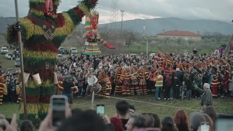 Caretos-effigy-towering-over-the-festive-crowd-in-Podence,-Portugal