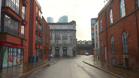 Profile-view-of-empty-streets-and-shops-of-Manchester,-England-on-a-weekend