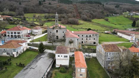 Aerial-pullback-from-front-of-Santa-Maria-de-Xunqueira-monastery-on-cloudy-day