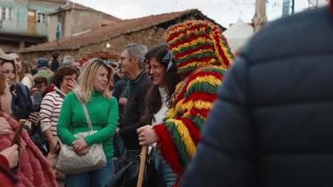 Careto-jingling-cowbells-near-women-"chocalhar"-at-Podence-fest,-Portugal