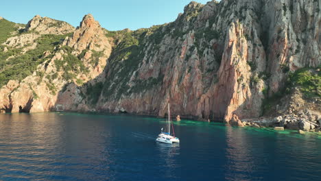 Crucero-En-Velero-Por-Las-Serenas-Aguas-Azules-Del-Golf-De-Girolata,-Córcega,-Flanqueado-Por-Escarpados-Acantilados.