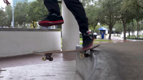 Skateboarder-performing-a-kickflip-back-tail-in-slow-motion-on-a-ledge