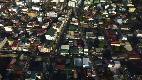 Drone-shot-over-colorful-dwellings-in-Tejeros,-golden-hour-in-Makati,-Philippines