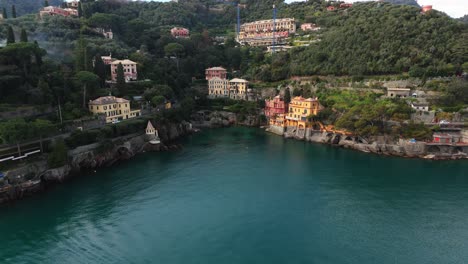 Coastal-Italian-village-of-Portofino-with-serene-sea-waters-and-picturesque-houses,-aerial-shot