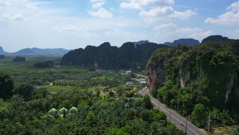 Tropical-landscape-karst-mountains-road-palm-trees