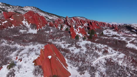 March-winter-morning-snow-stunning-Roxborough-State-Park-Littleton-Colorado-aerial-drone-landscape-sharp-jagged-dramatic-red-rock-formations-Denver-foothills-front-range-blue-sky-forward-reveal