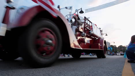 Footage-of-a-vintage-fire-truck-as-it-drives-down-West-Main-Street-in-Belleville,-IL-during-the-annual-Ainad-Shriners-Parade