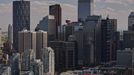 Calgary-AB-Canada-Aerial-v20-zoomed-drone-flyover-Eau-Claire-across-Downtown-Commercial,-reveals-landmark-observation-tower-hidden-behind-towering-skyscrapers---Shot-with-Mavic-3-Pro-Cine---July-2023