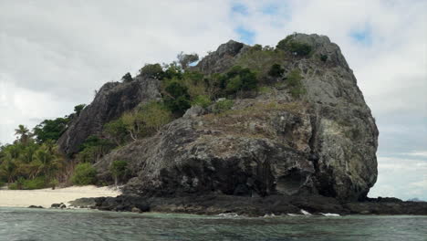 Castaway-Qalito-Malolo-Island-Tourism-Fiji-boat-ride-sailboat-Roro-Reef-coral-white-sandy-shores-rocky-boulder-hillside-tropical-palm-tree-paradise-Mamanuca-group-nature-landscape-breezy-right