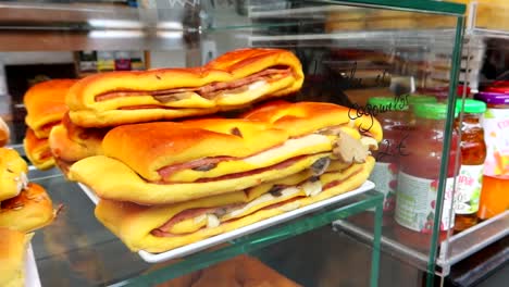 Freshly-made-Portuguese-sandwiches-filled-with-cheese,-ham-and-mushrooms