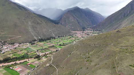 Aerial-Drone-view-of-Ollantaytambo-Inca-city-town-in-Peru-mountains-and-Inca-ruins