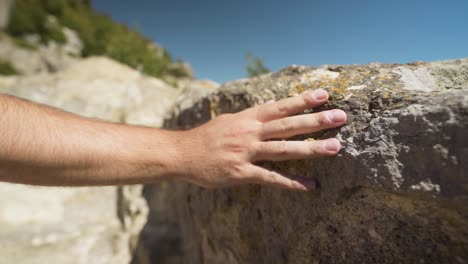 Male-Hand-Touching-Rock-In-Ancient-Sanctuary-City-Perperikon,-Bulgaria