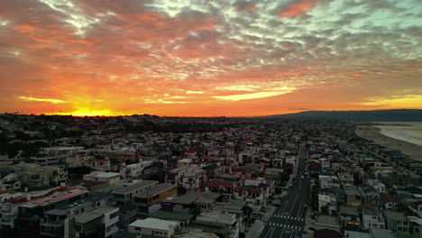 Aerial-View-of-Manhattan-Beach,-California-USA-at-Sunrise,-Orange-Clouds-Above-Cityscape