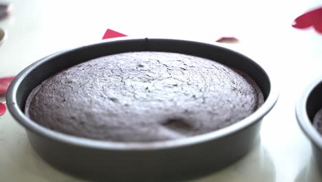 Slow-pan-across-table-of-two-freshly-baked-chocolate-cakes-vegan-chocolate-cake-eggless-plant-based-dairy-free