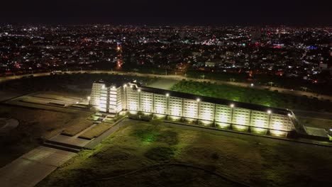 Illuminated-concrete-memorial-Faro-a-Colon-in-Santo-Domingo,-nigh-aerial-arc